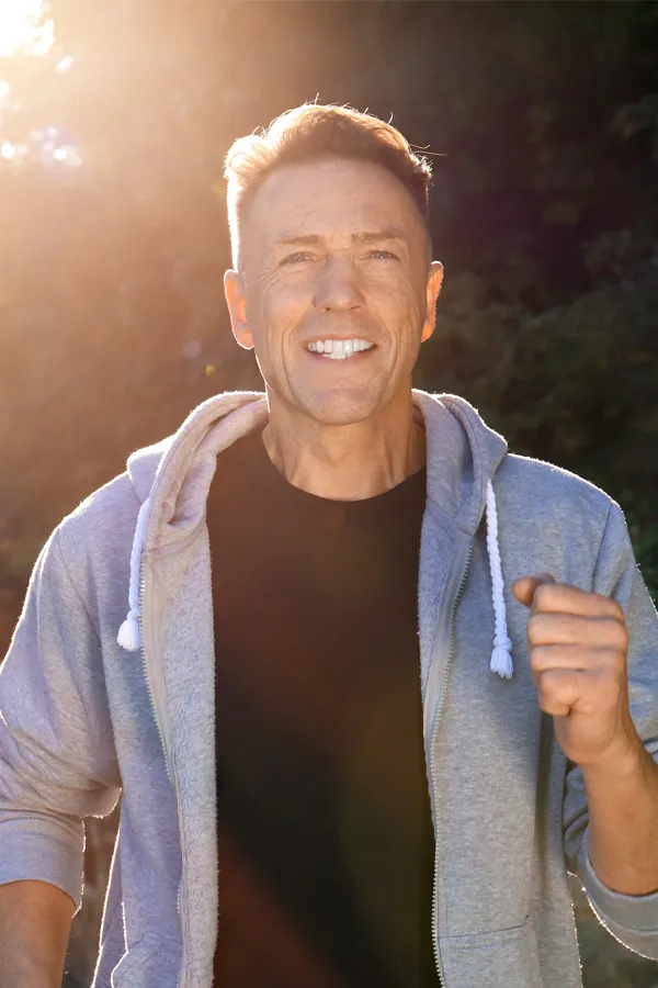 Bursitis-Treatment A smiling middle-aged man prepares for morning exercise. Get treatment for Bursitis from Lux Hormones & Health Wellness in San Diego.