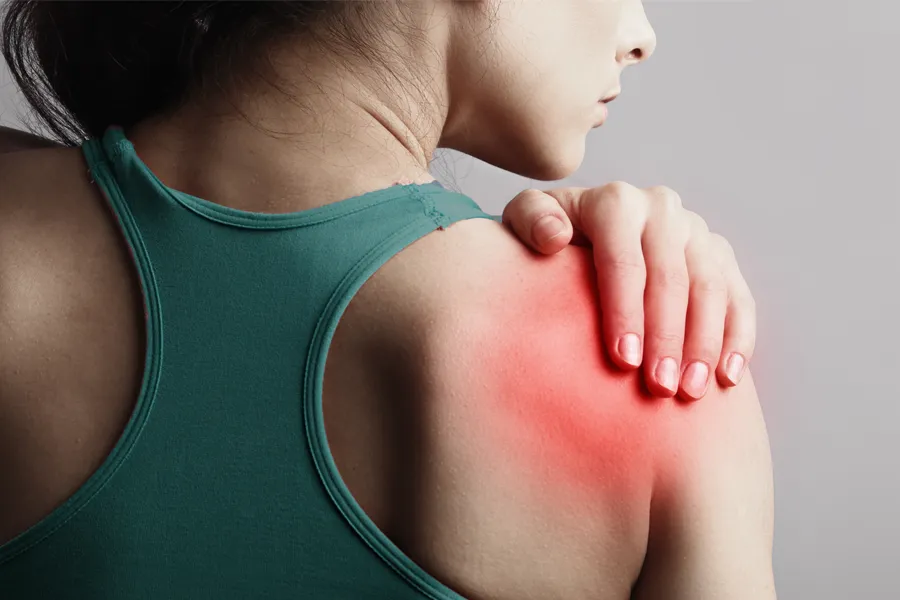 Labrum-Tears-Clinic A woman holds her shoulder in pain. Schedule treatment for larum tears from Lux Hormones & Health Wellness in San Diego.