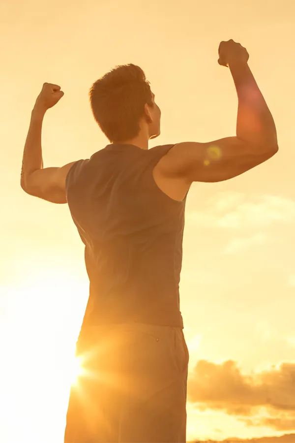 Lux-Weight-Loss-Plans-Treatment A man raises his fists in triumph in the sunset. Get the Lux weight loss plan from Lux Hormones & Health Wellness in San Diego.