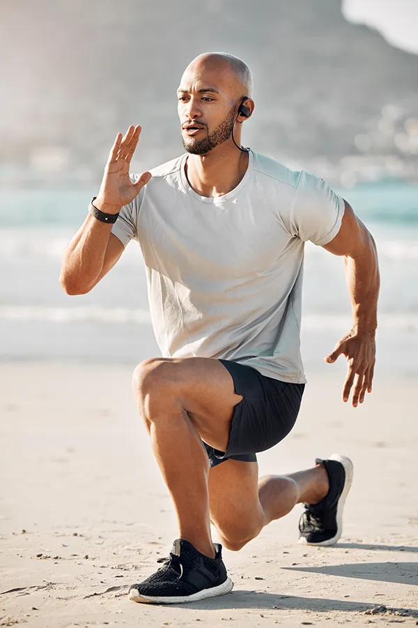MCL-Tears-Treatment A man does lunges on the beach. Get treatment for MCL tears from Lux Hormones & Health Wellness in San Diego.
